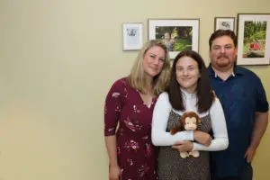 Jennifer and Ian Bost with their daughter Emma, holding a stuffed animal to be donated to the UW Medical Center NICU