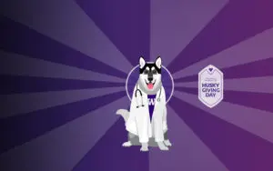 An illustration of Dr. Dubs, a husky dog wearing a lab coat and stethoscope, next to the Husky Giving Day logo, against a two-tone purple background