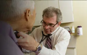 Dr. Irl Hirsch examines a patient