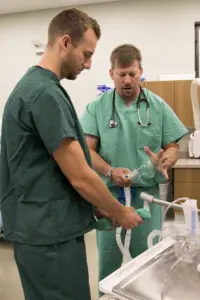 Preceptor Dr. Geoff Jones shows endoscopy equipment to second-year medical student Nic Carey at Newport Family Health Center in Newport, WA.