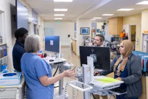 Surgery resident Dr. Chris Marfo, Margaret Taylor-Law, RN, general surgeon Dr. Scott Brakenridge, MD, resident of Anethesiology & Pain Medicine Dr. Elaa Mahdi, MD, in the Trauma/Surgical Critical Care Service Intensive Care Unit at Harborview Medical Center.