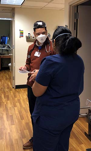 Gaskins speaking with a nurse during a Family Medicine rotation in Tacoma.