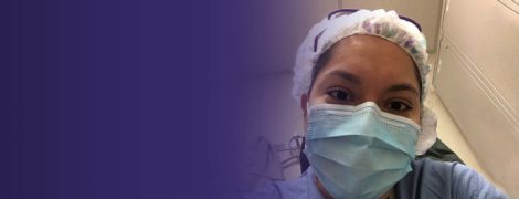 Karina Diaz, MD-PhD, wearing scrubs and PPE (personal protective equipment).