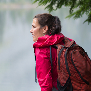Carolyn Busch hiking alongside a lake