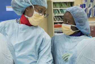 First-year medical student Dorender Dankwa shadows resident Dr. Estell Williams during a cholecystectomy (gallbladder removal) at UW Medical Center.