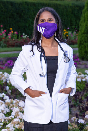 Medical student wearing a white coat.