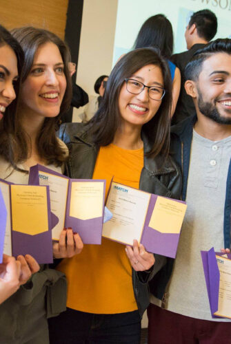 Four UW School of Medicine students pose with their match location information on Match Day 2023.