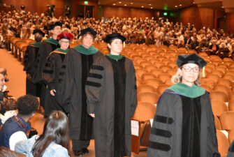 UW School of Medicine faculty members processing down the aisle during 2023's Stethoscope Ceremony.