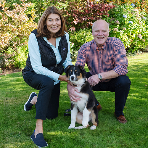 Kathleen and Brooks Simpson outside with their dog.