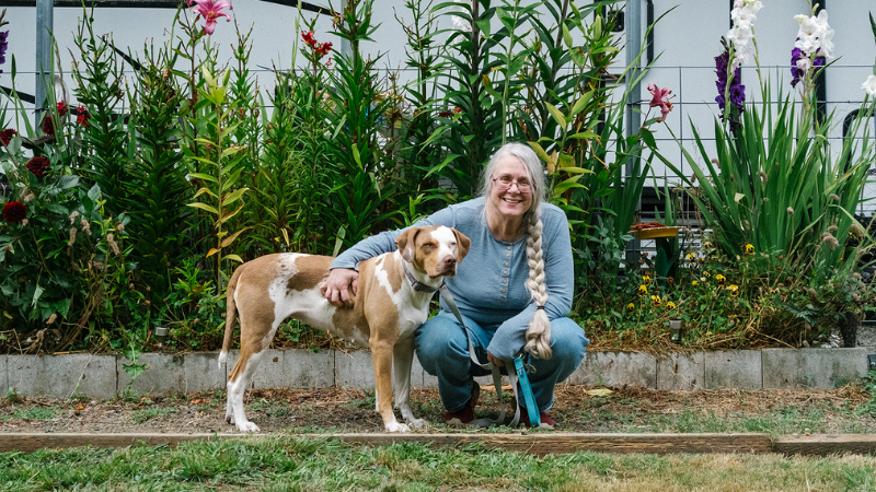 Pat Thorp outside her house with her dog