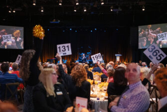 Event attendees during the raise the paddle at The Benefit 2024