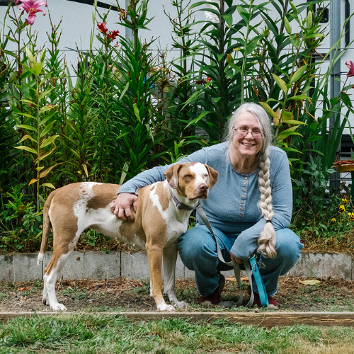 Pat Thorp with her dog outside in her yard.