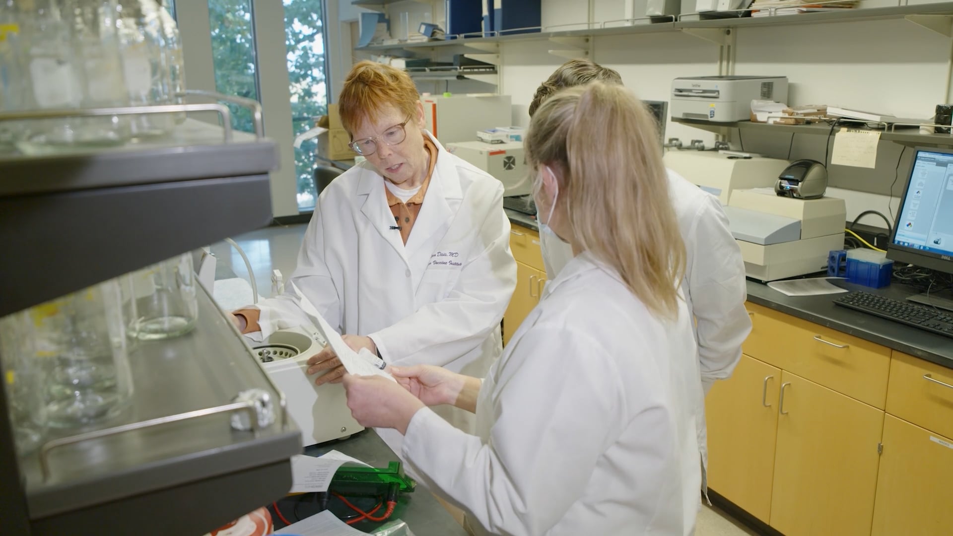 Dr. Nora Disis works with researchers in a lab at the Cancer Vaccine Institute.