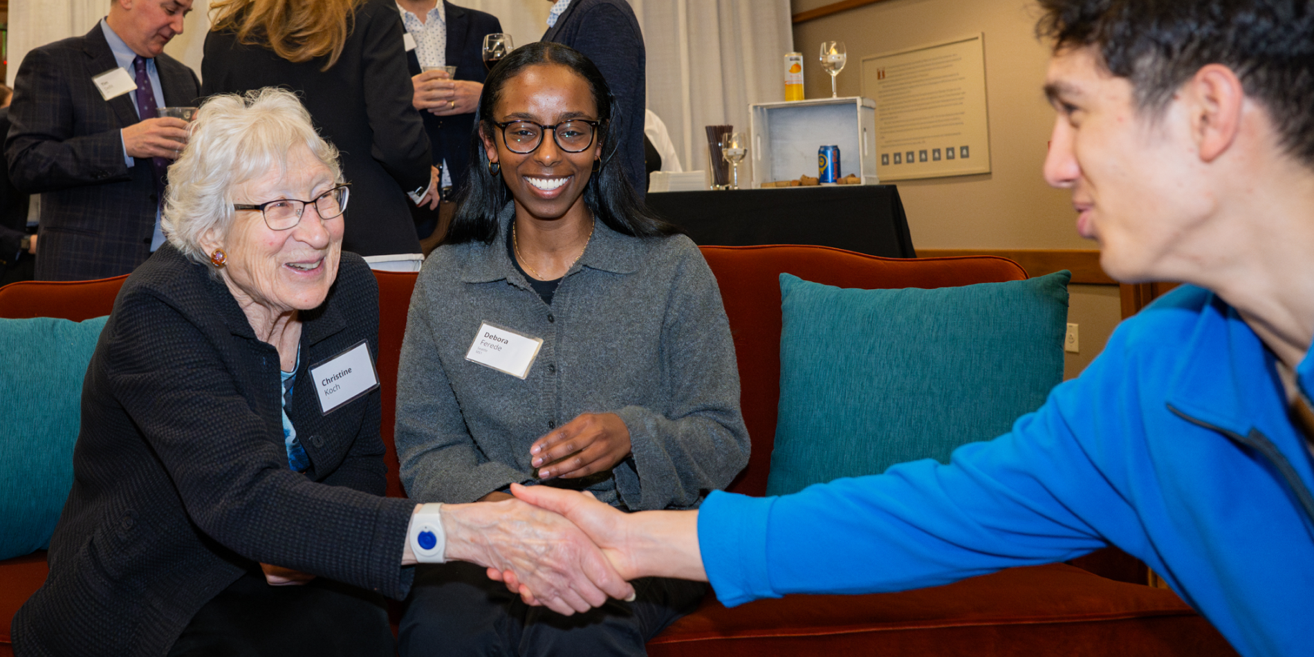 Christine Koch shaking hands with a student at Scholarship Social 2024.