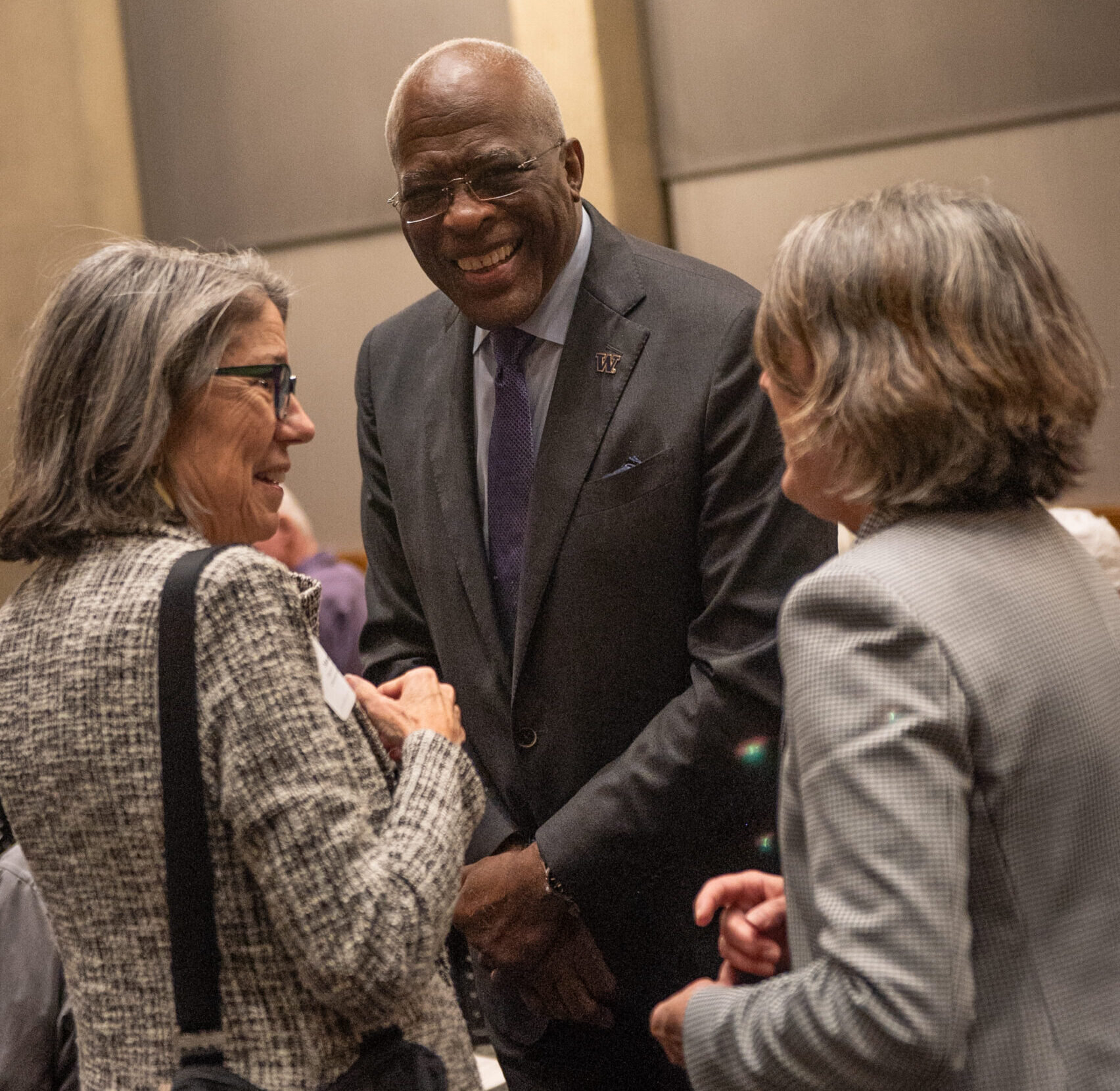 UW President Dr. Robert J. Jones laughing with attendees at a Henry Suzzalo Society event.