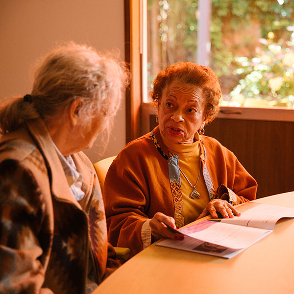 Two patients talk at the Memory Hub.